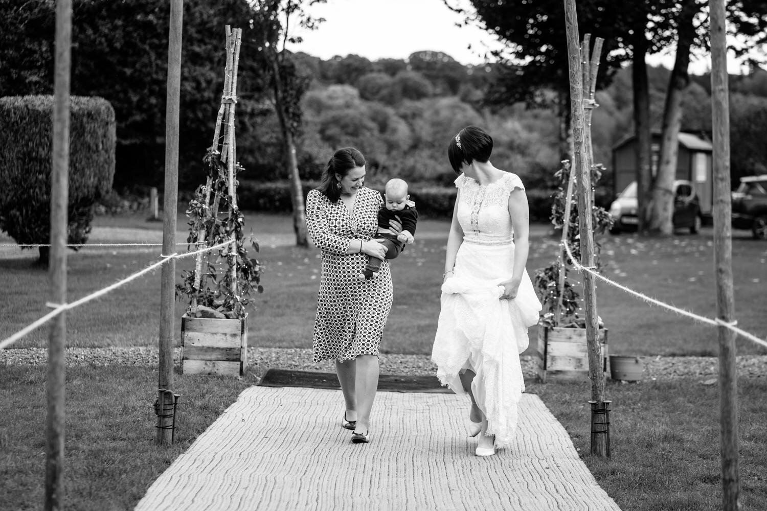 Bride with wedding guest and baby