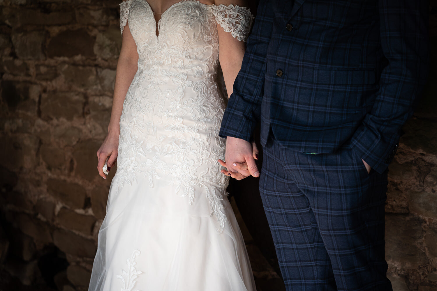 Groom and bride hold hands at Lyde Court