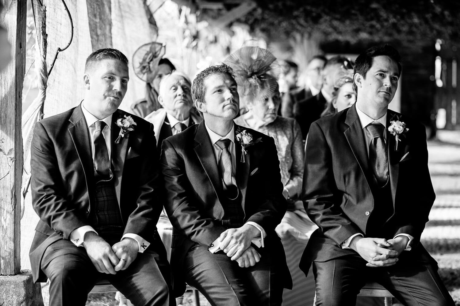 Best men looking on Lyde Court wedding ceremony