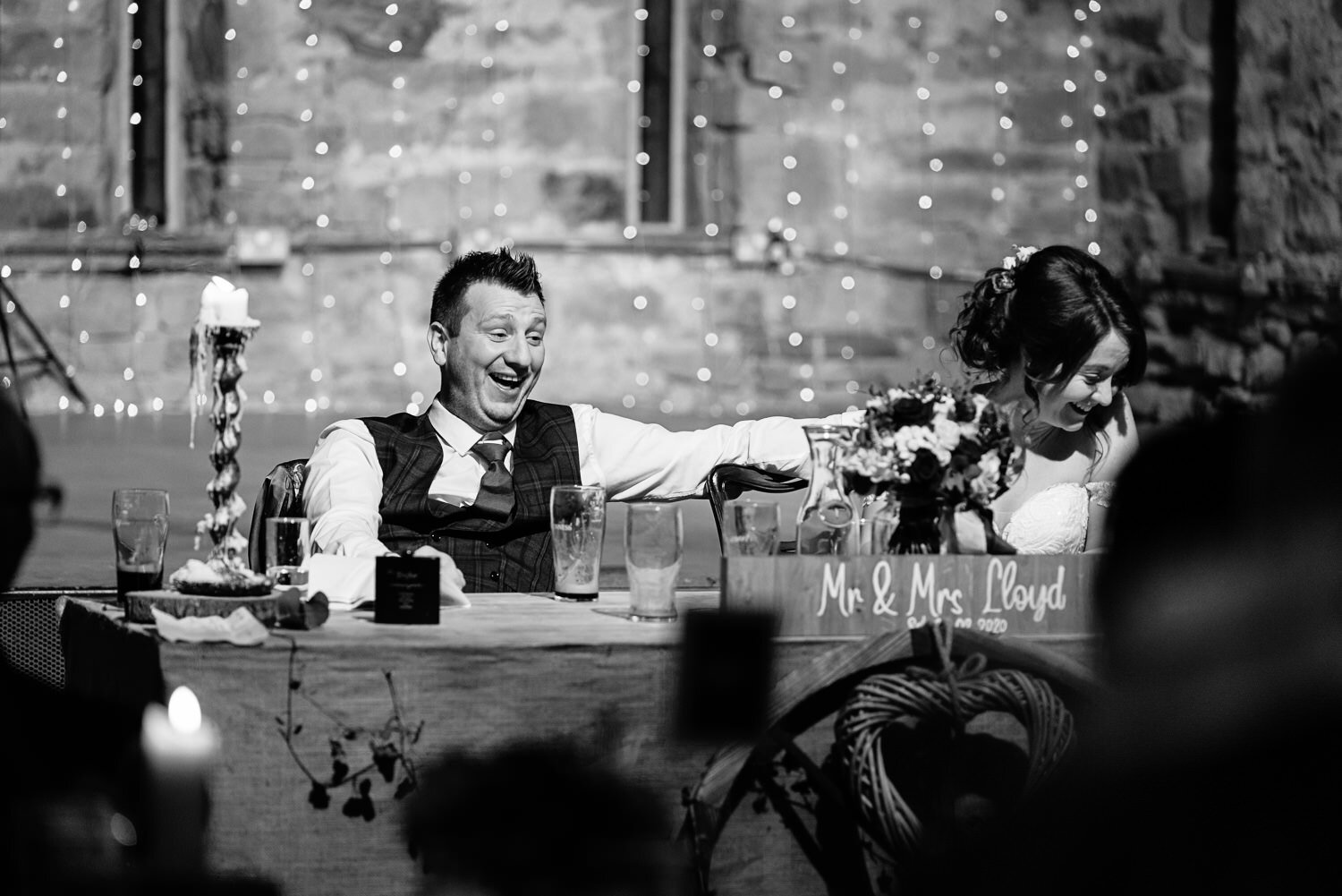 Groom and bride laughing at Lyde Court wedding speeches