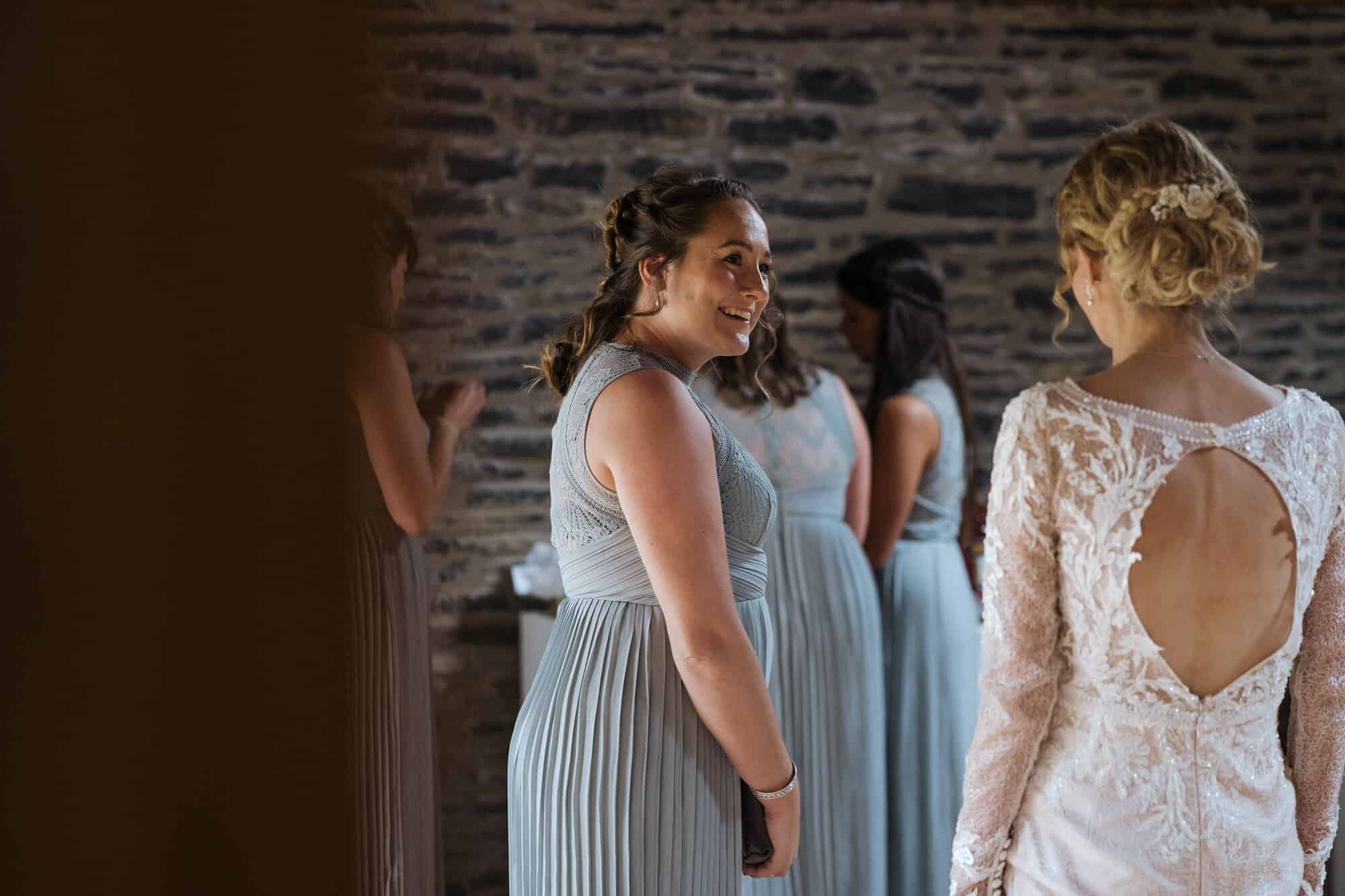 Bridesmaid and bride laughing