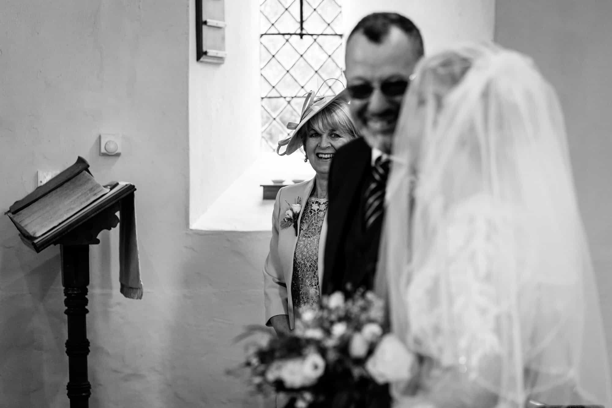 Brides mother looking at bride in church