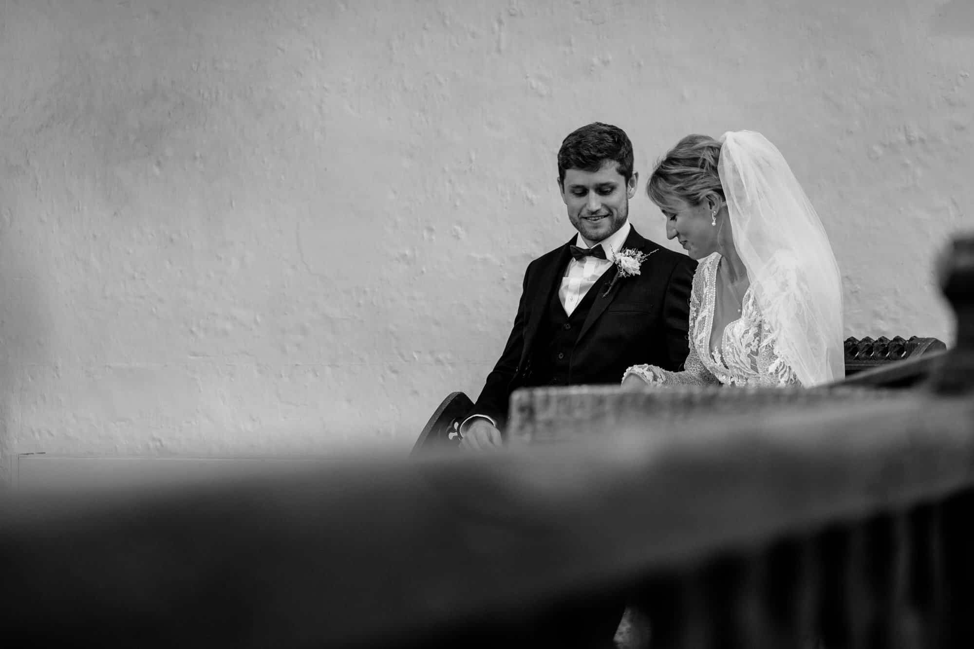 Relaxed moment between bride and groom in church