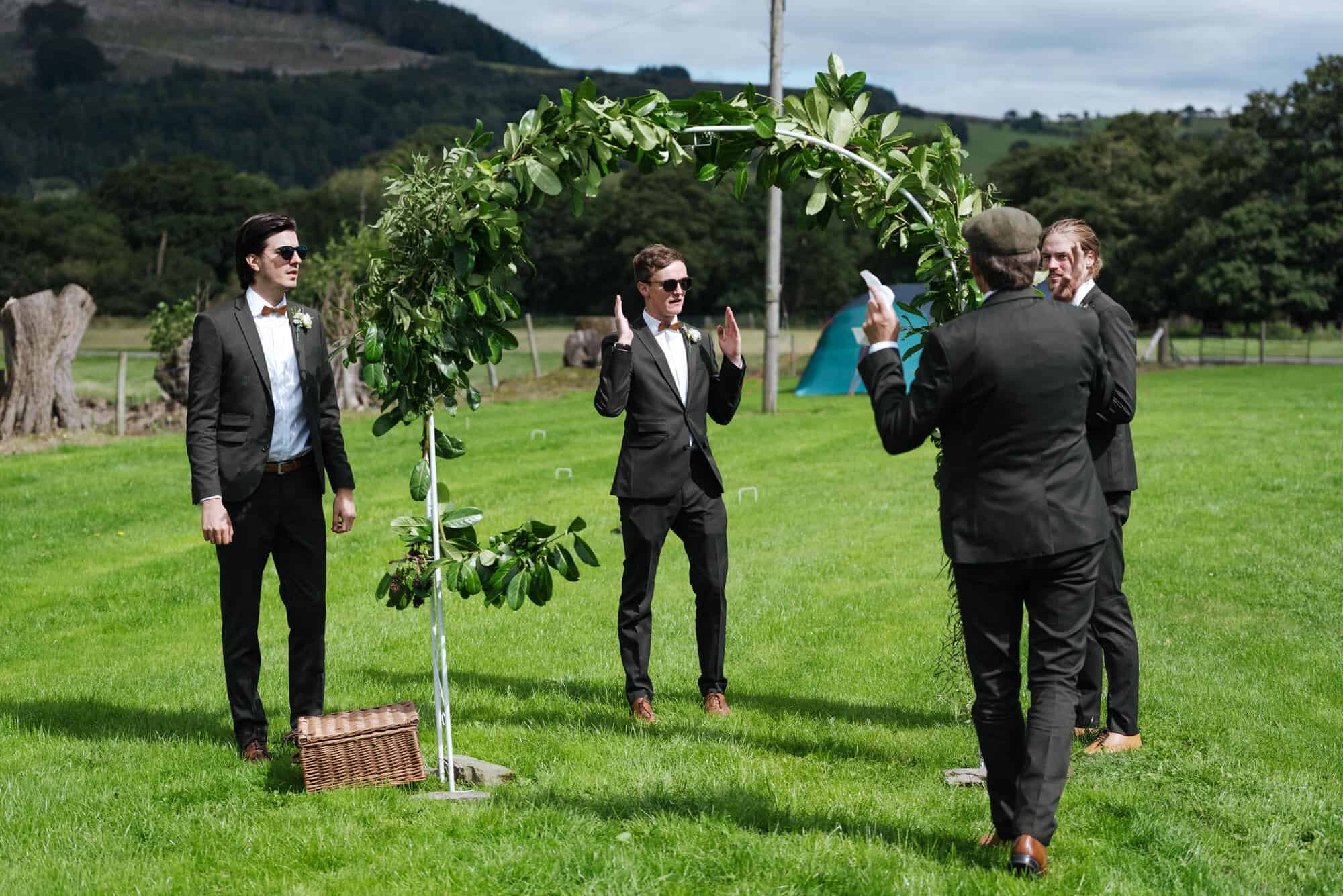 Ushers deciding where to put wedding arch