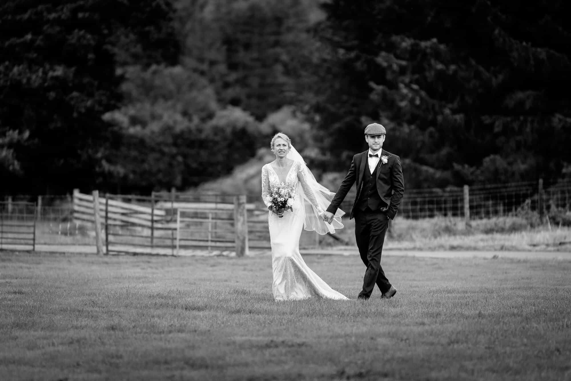 Newly weds walking naturally togetherBride and groom taking a walk