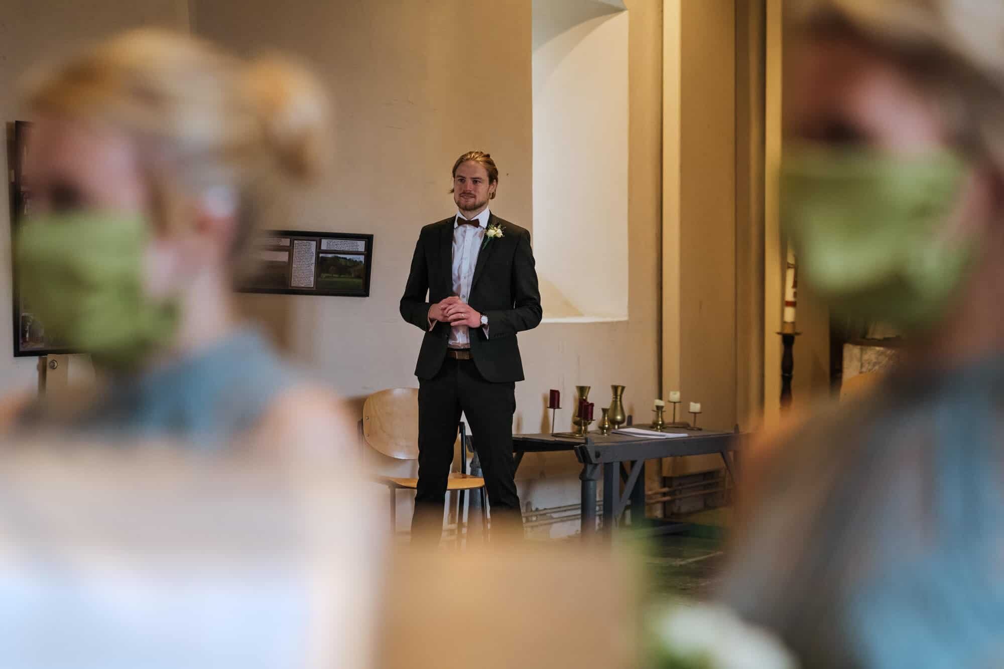 Socially distanced wedding guest in church