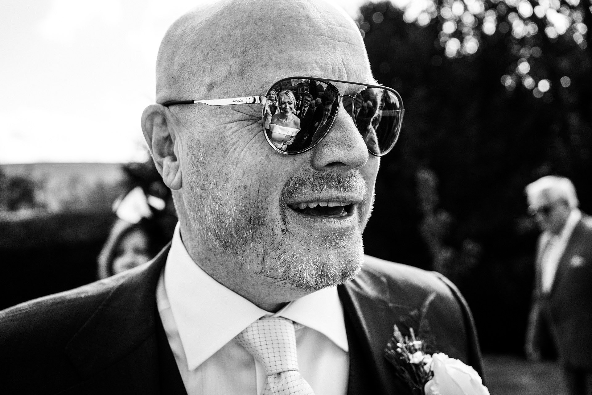 Groom wearing sunglasses at wedding
