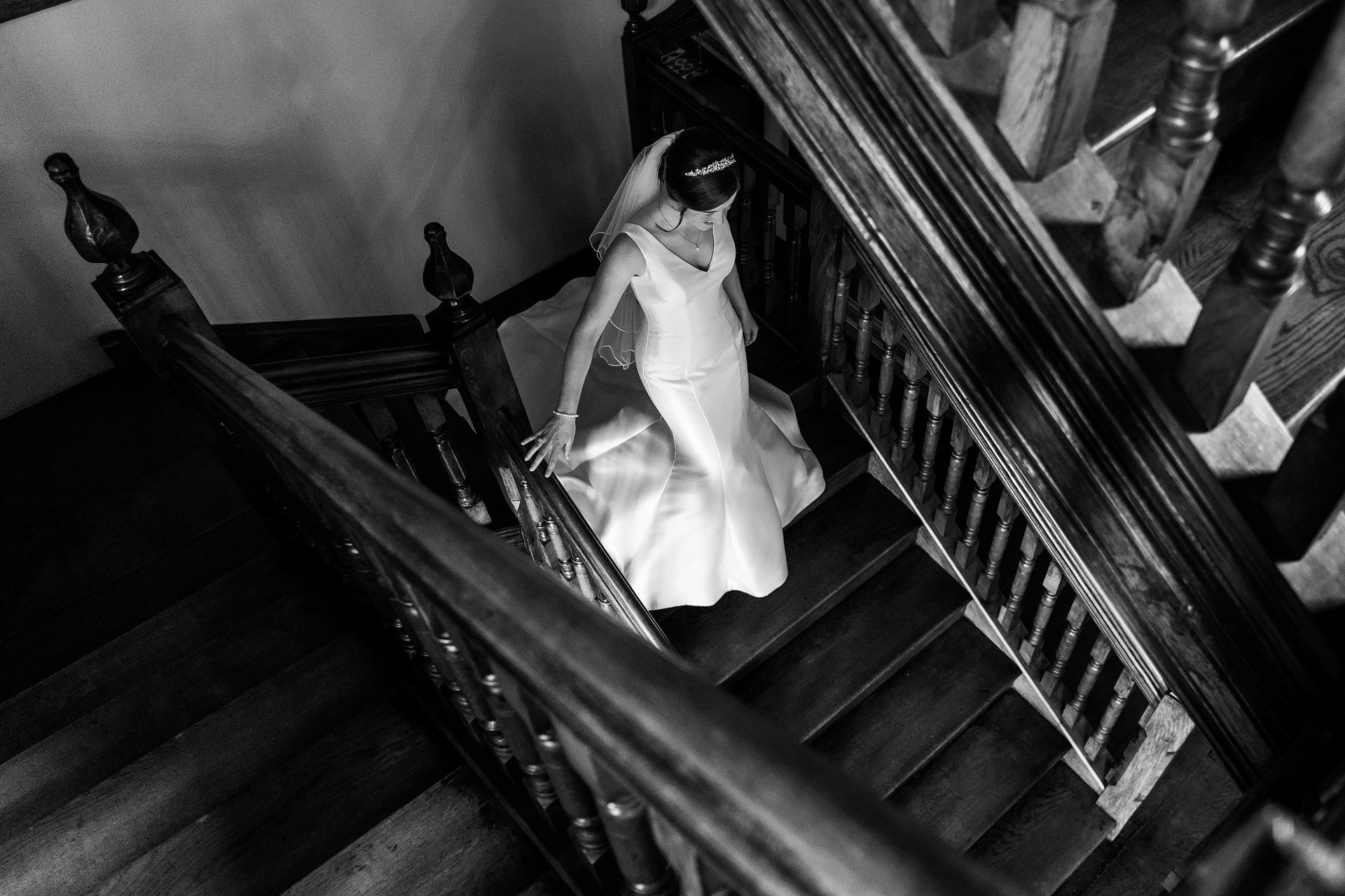 Bride walking downstairs at Dewsall Court