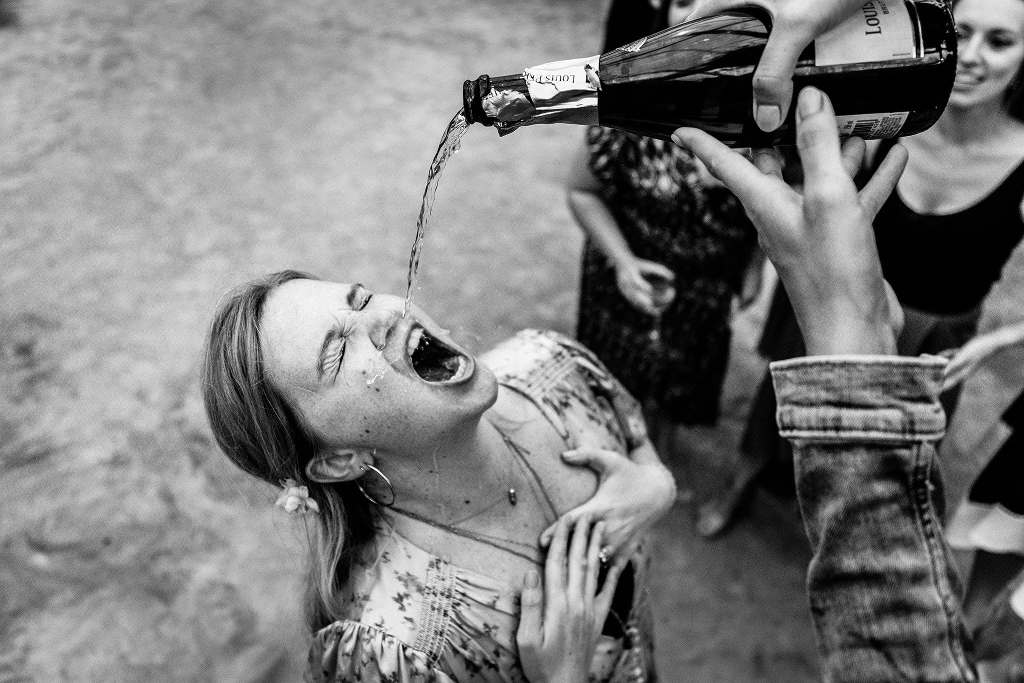 Champagne poured into wedding guests mouth