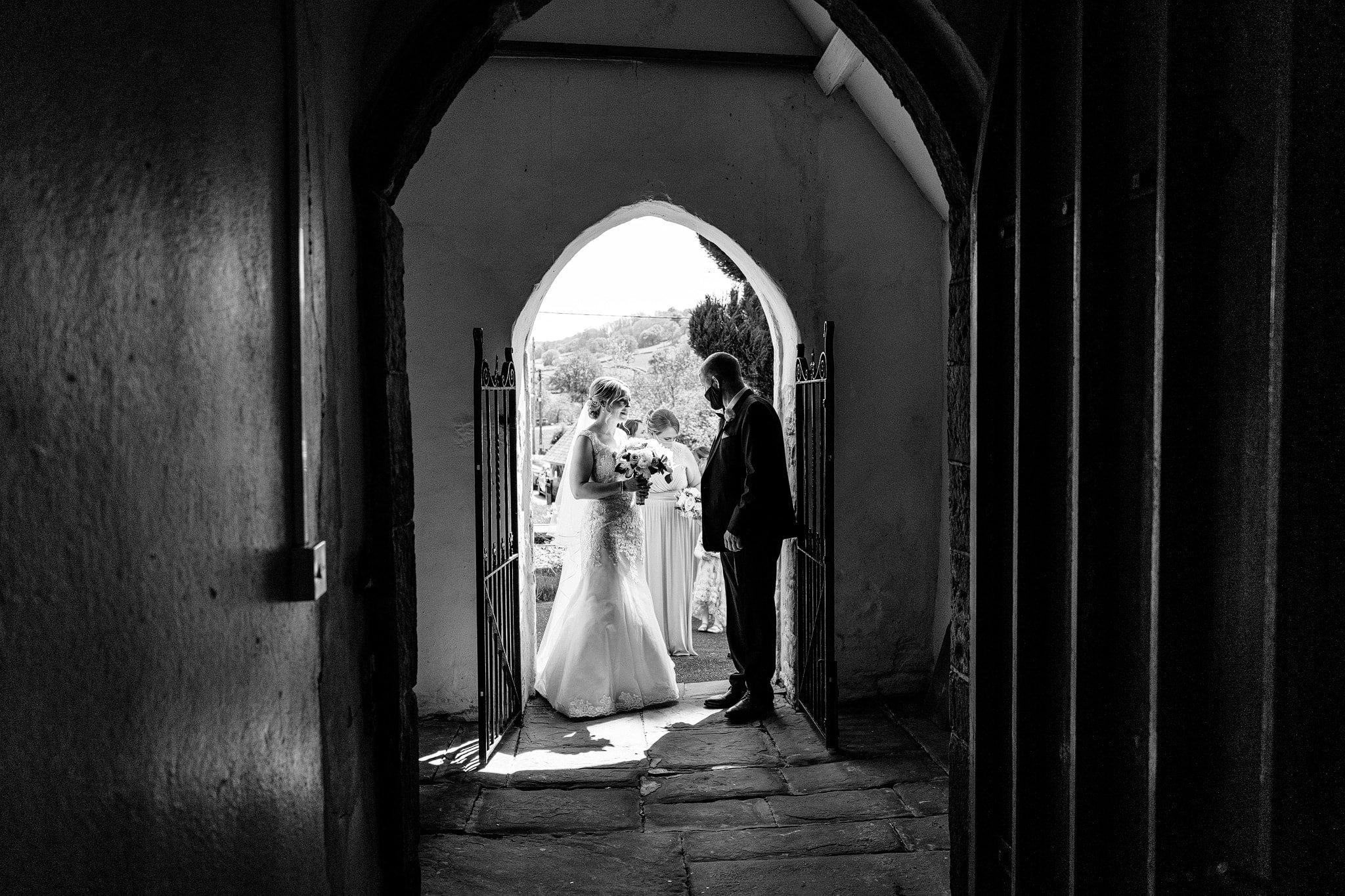 Bride standing with dad in church entrance