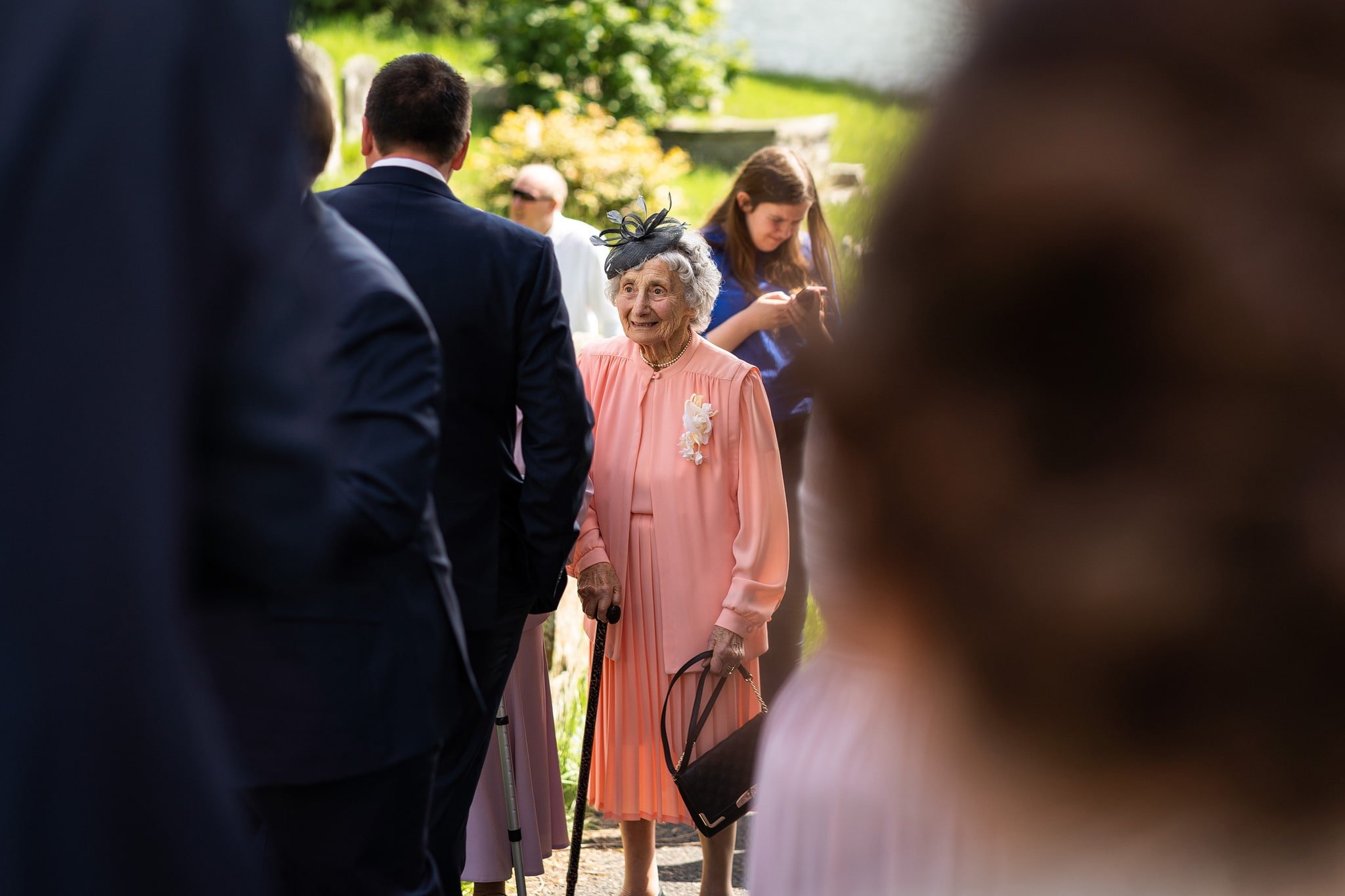 Gran standing with guests outside church