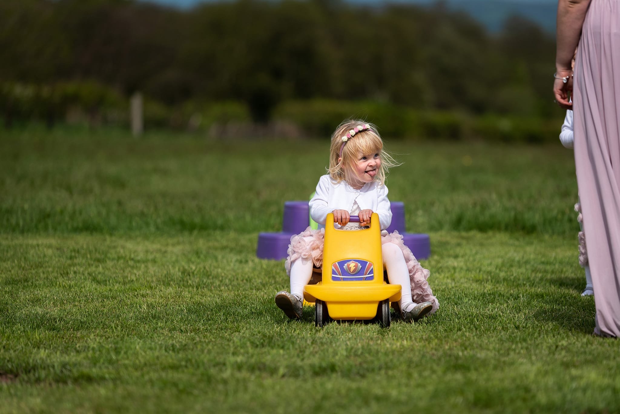 Young flower girl playing with toys 