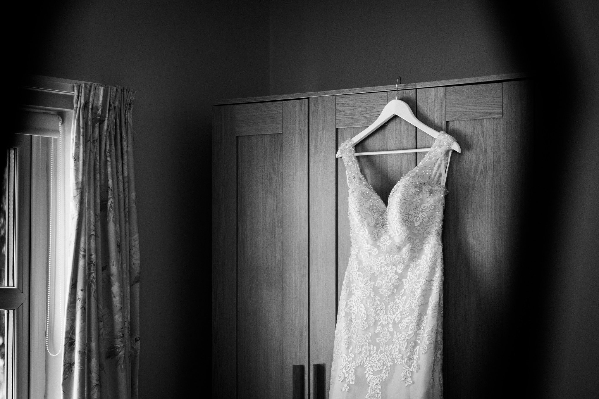 Wedding dress hanging on wardrobe