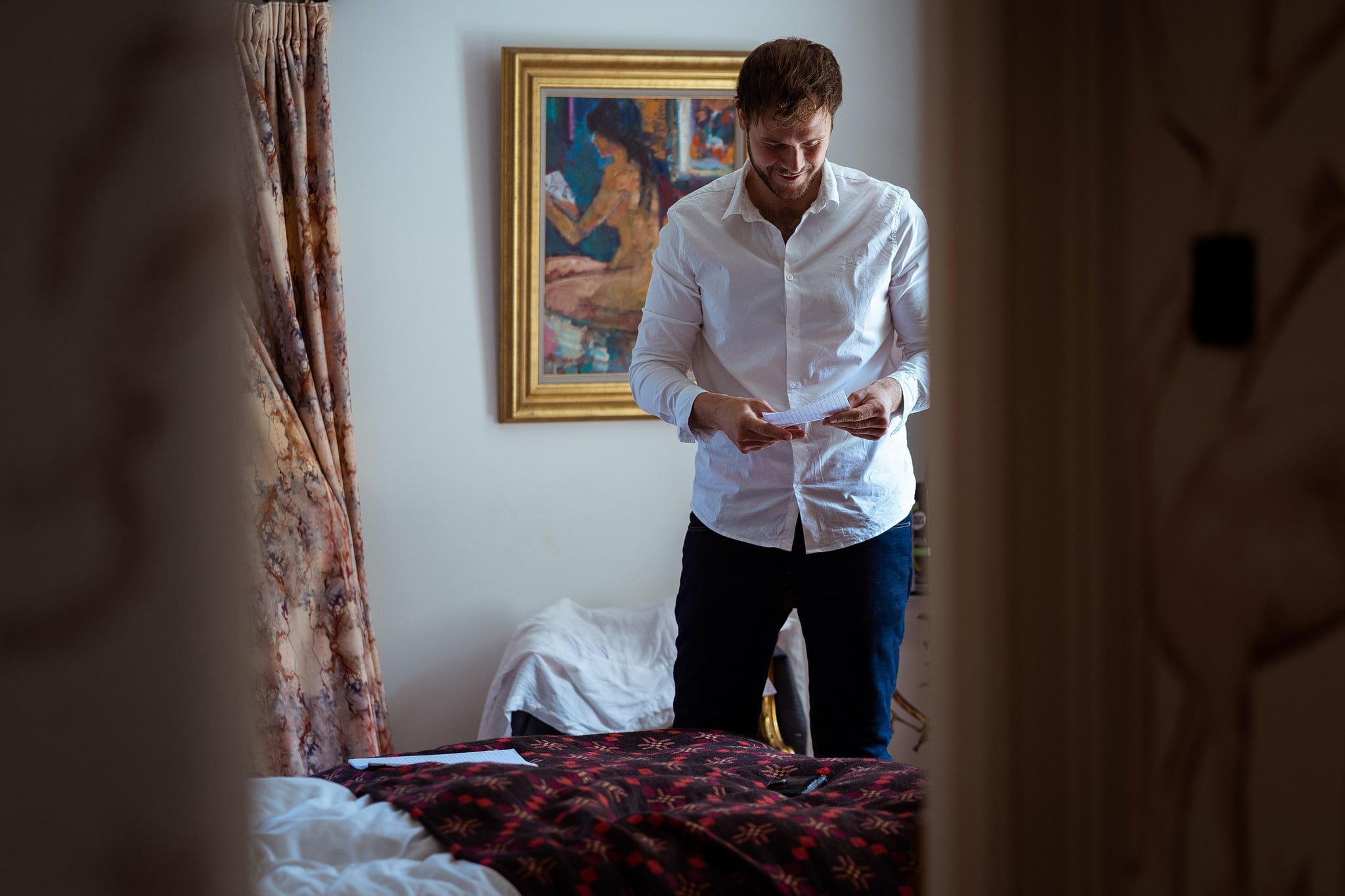 Groom reading speech on wedding morning