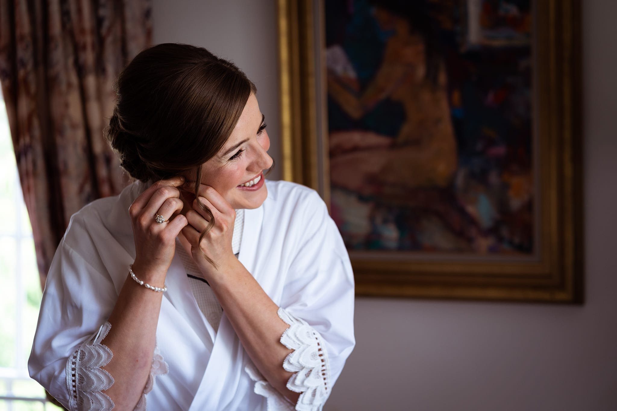 Bride putting ear rings in