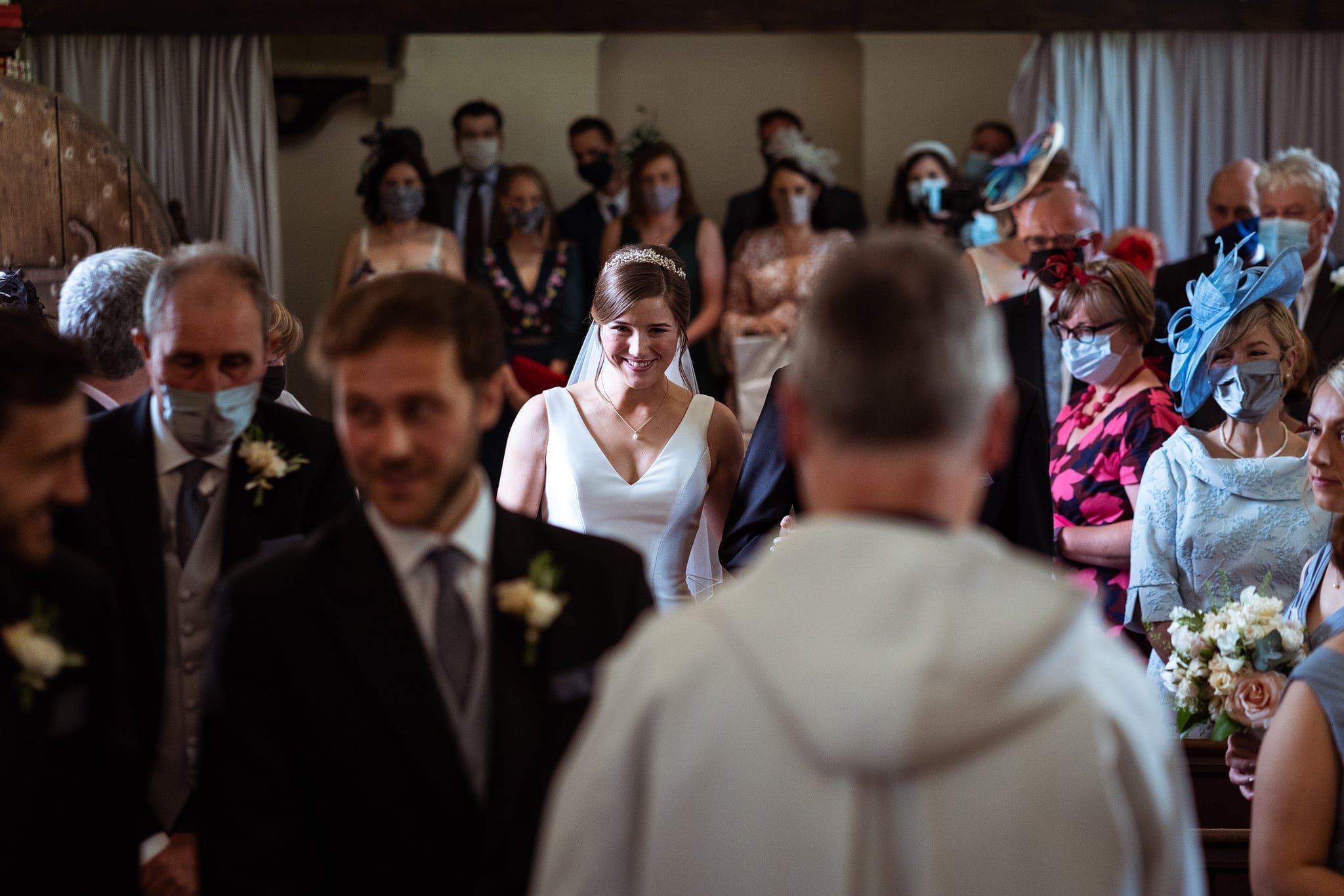 Bride walking down aisle at Dewsall Court church