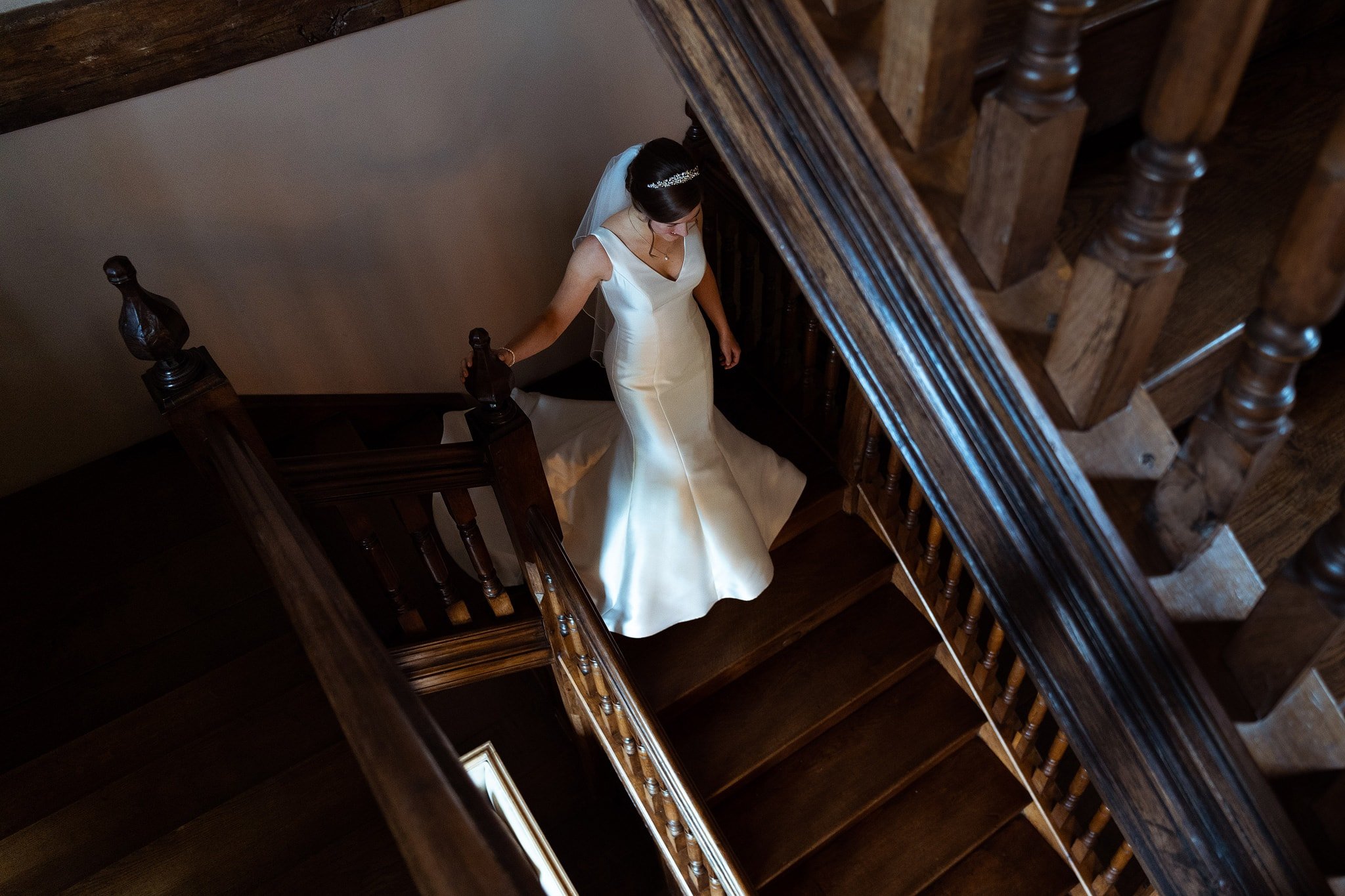 Bride walking down stairs at Dewsall Court