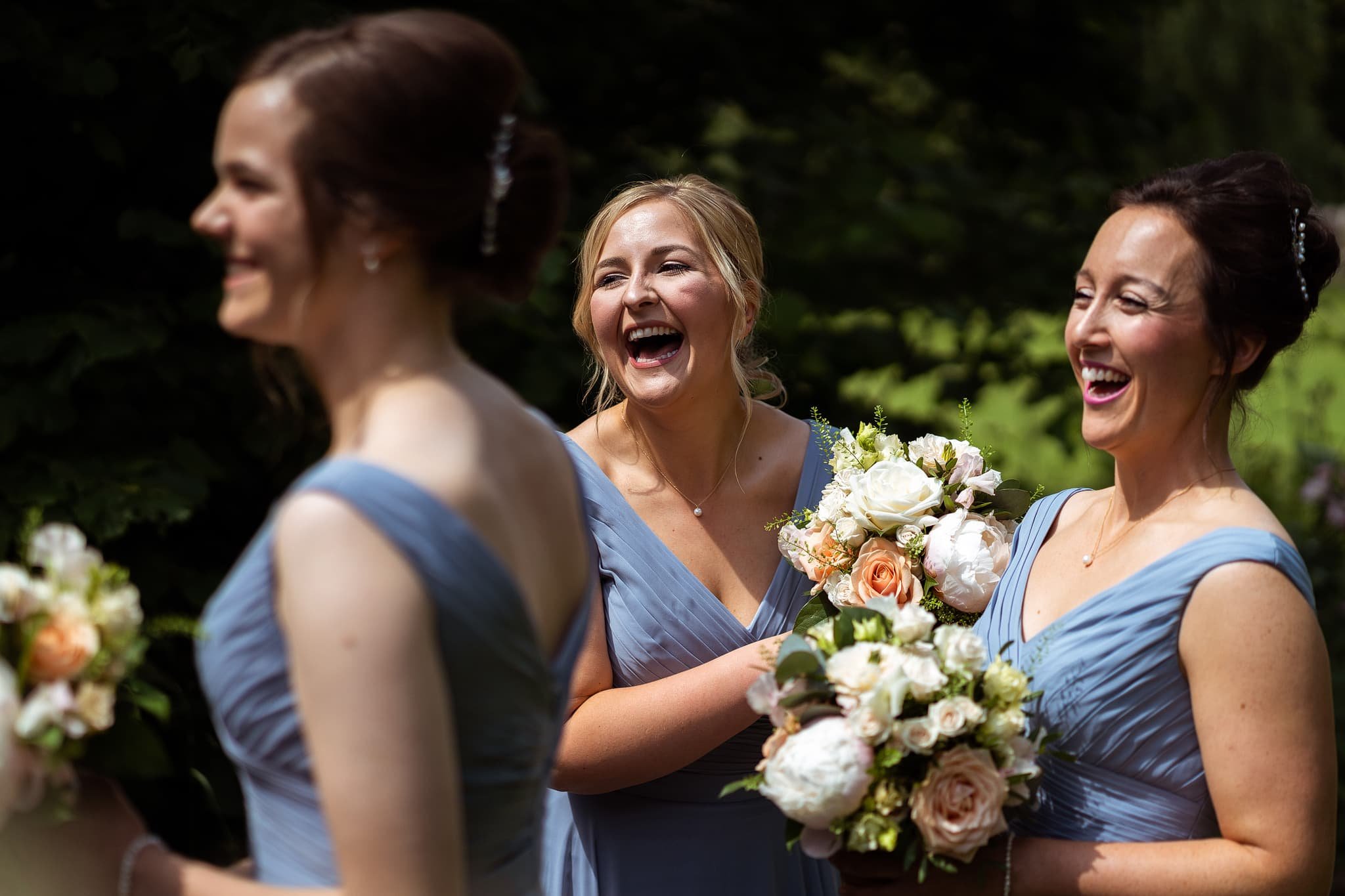 Bridesmaids laughing at Dewsall Court