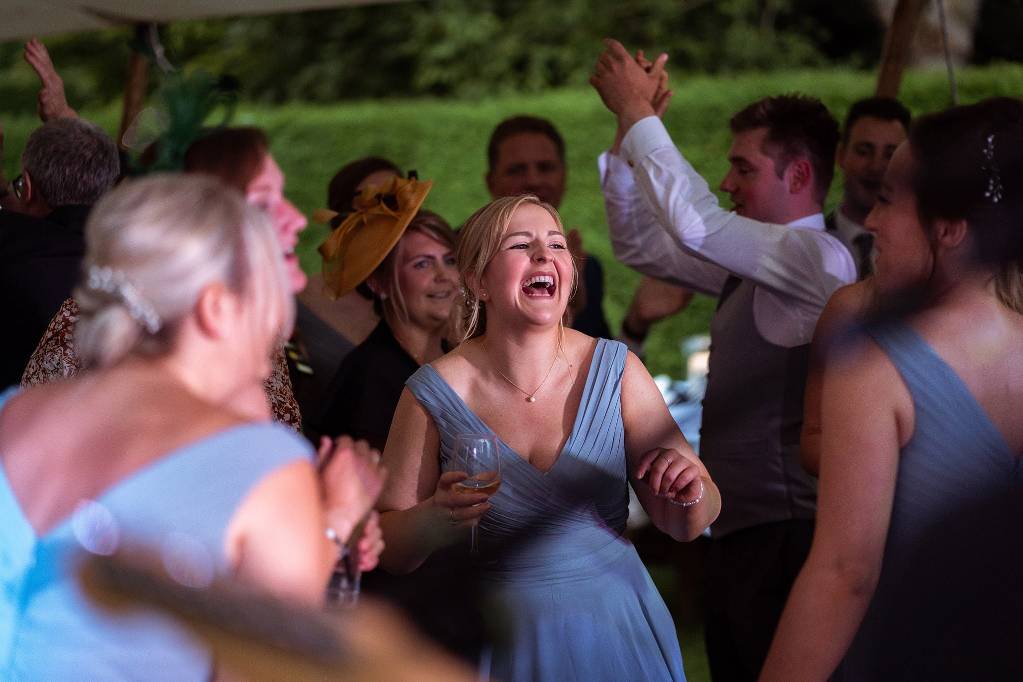 Bridesmaids dancing and laughing at party