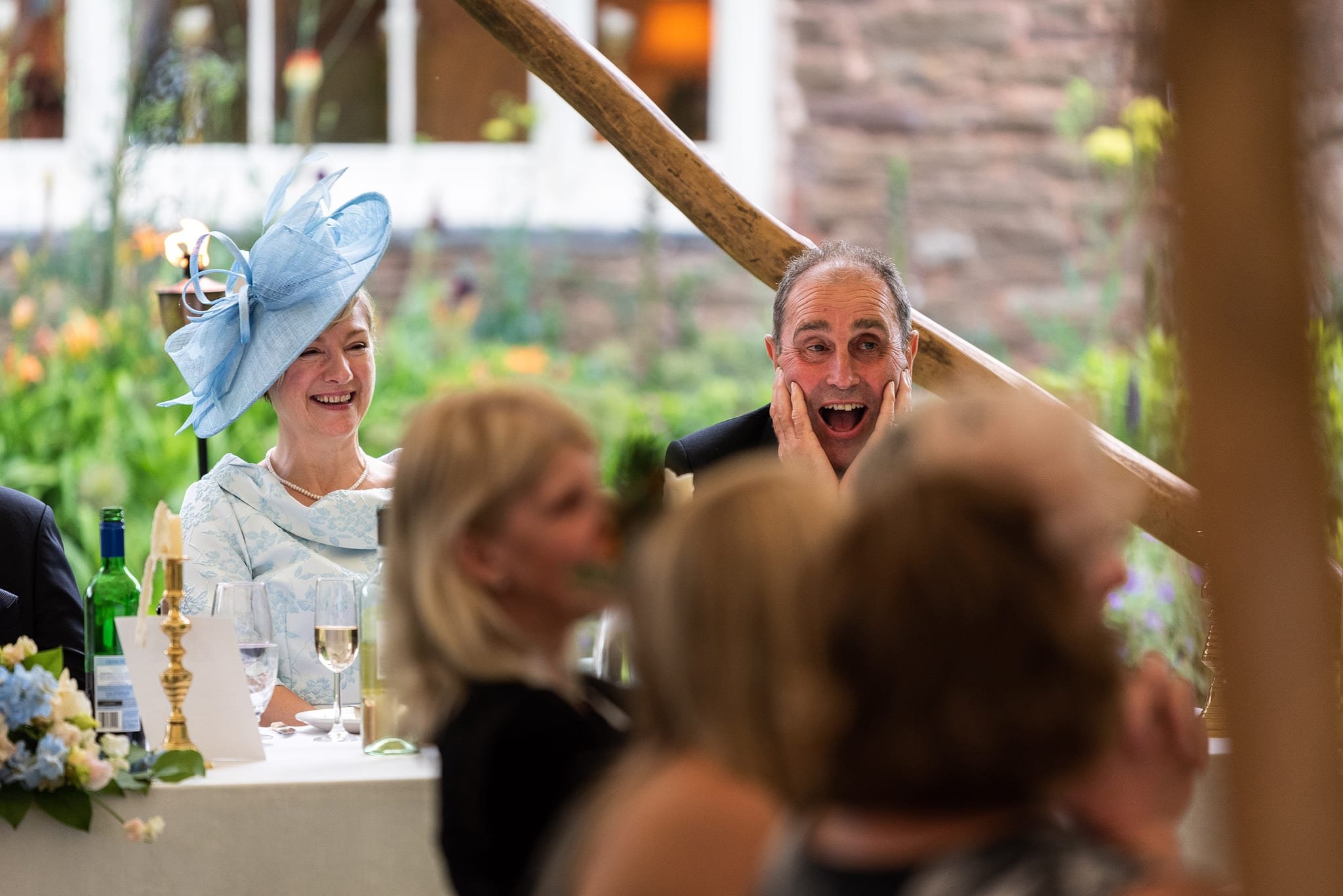 Guests laughing during speeches at Dewsall Court