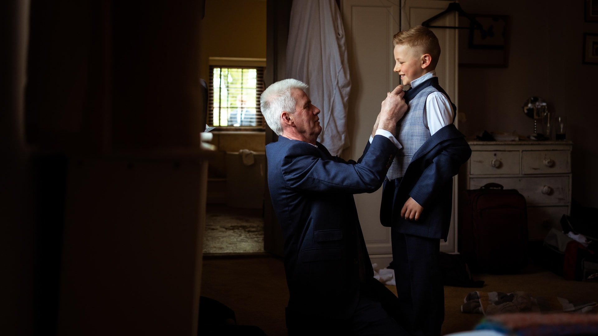 Father of bride doing grandsons tie up