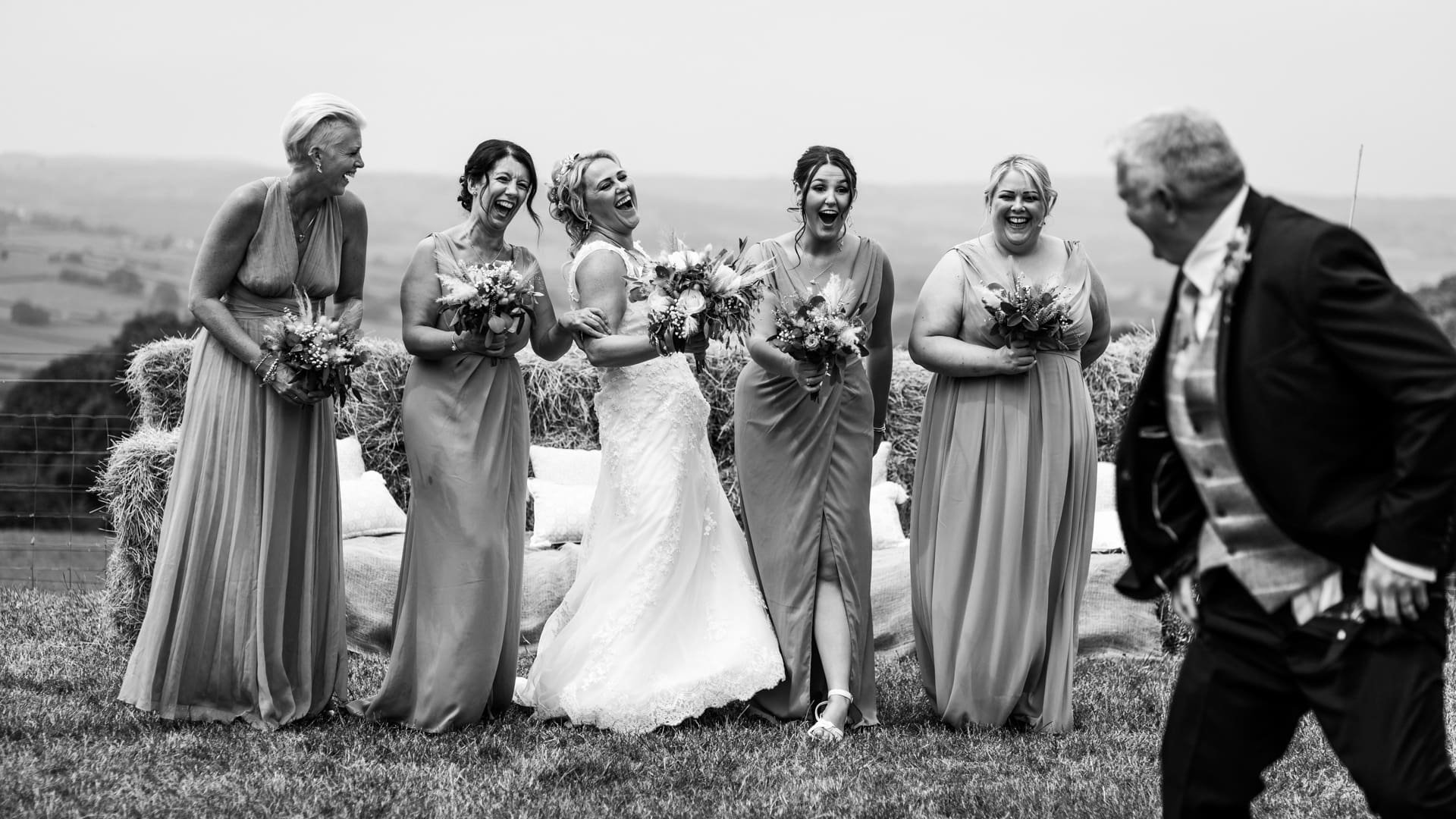 Bride and guests laughing at grooms bum