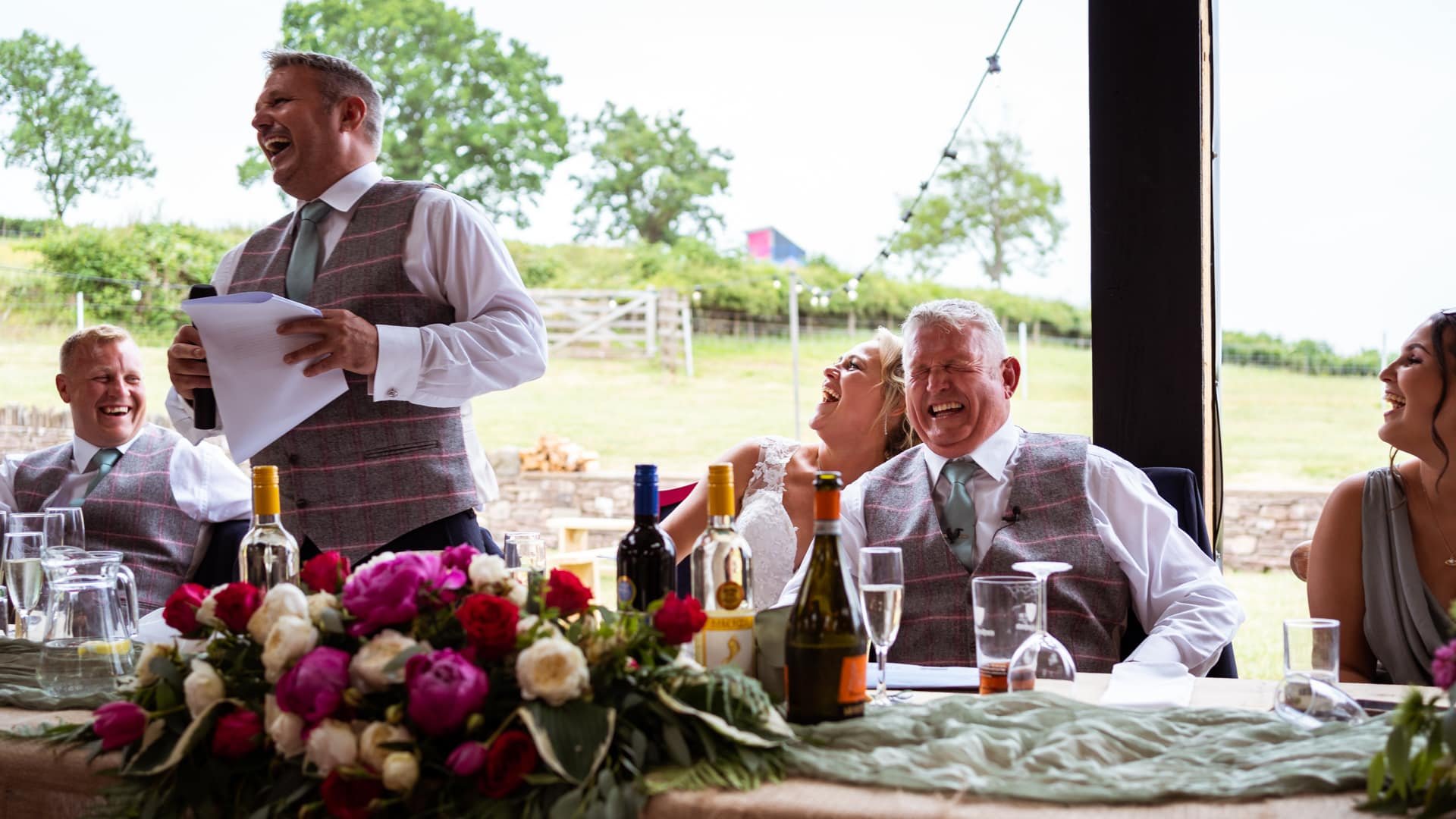 Bride &amp; groom laughing during speeches at The Wholehouse