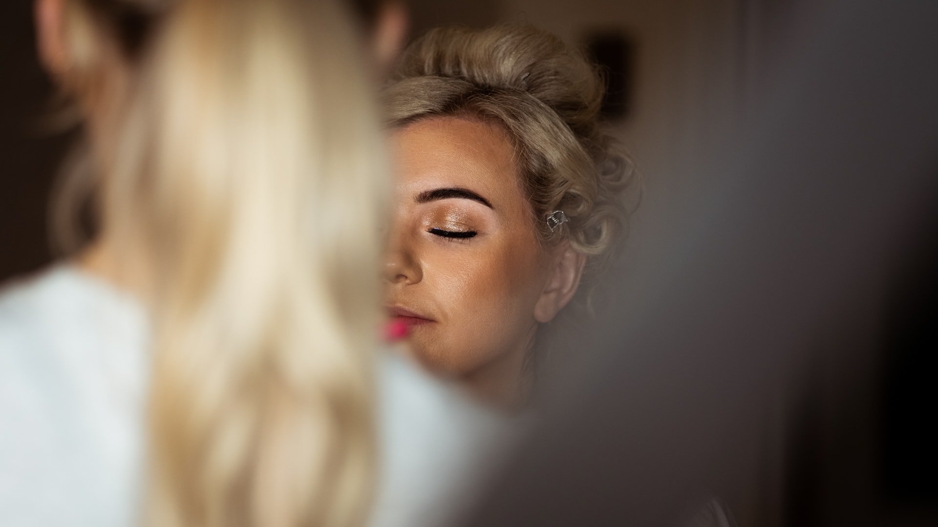 Bride having makeup applied at Talhenbont Hall