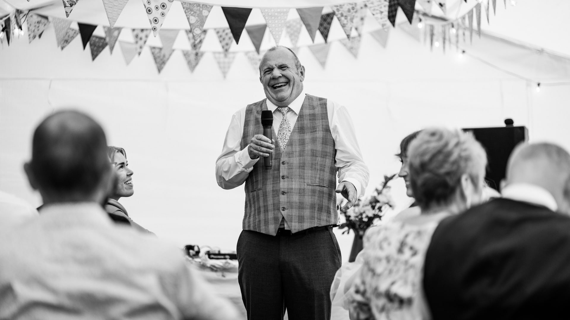 father of bride laughing during wedding speech