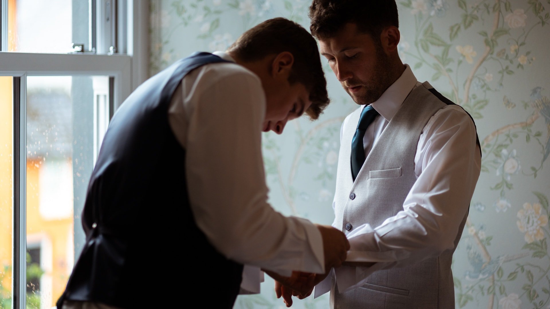 Best man and groom during groom prep