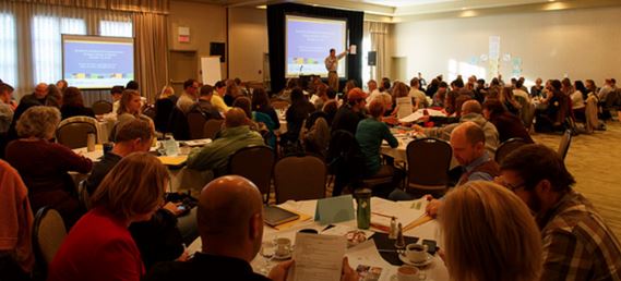 The author (gesticulating) in the company of 120 of Alberta’ best and brightest educators, at the Summit.