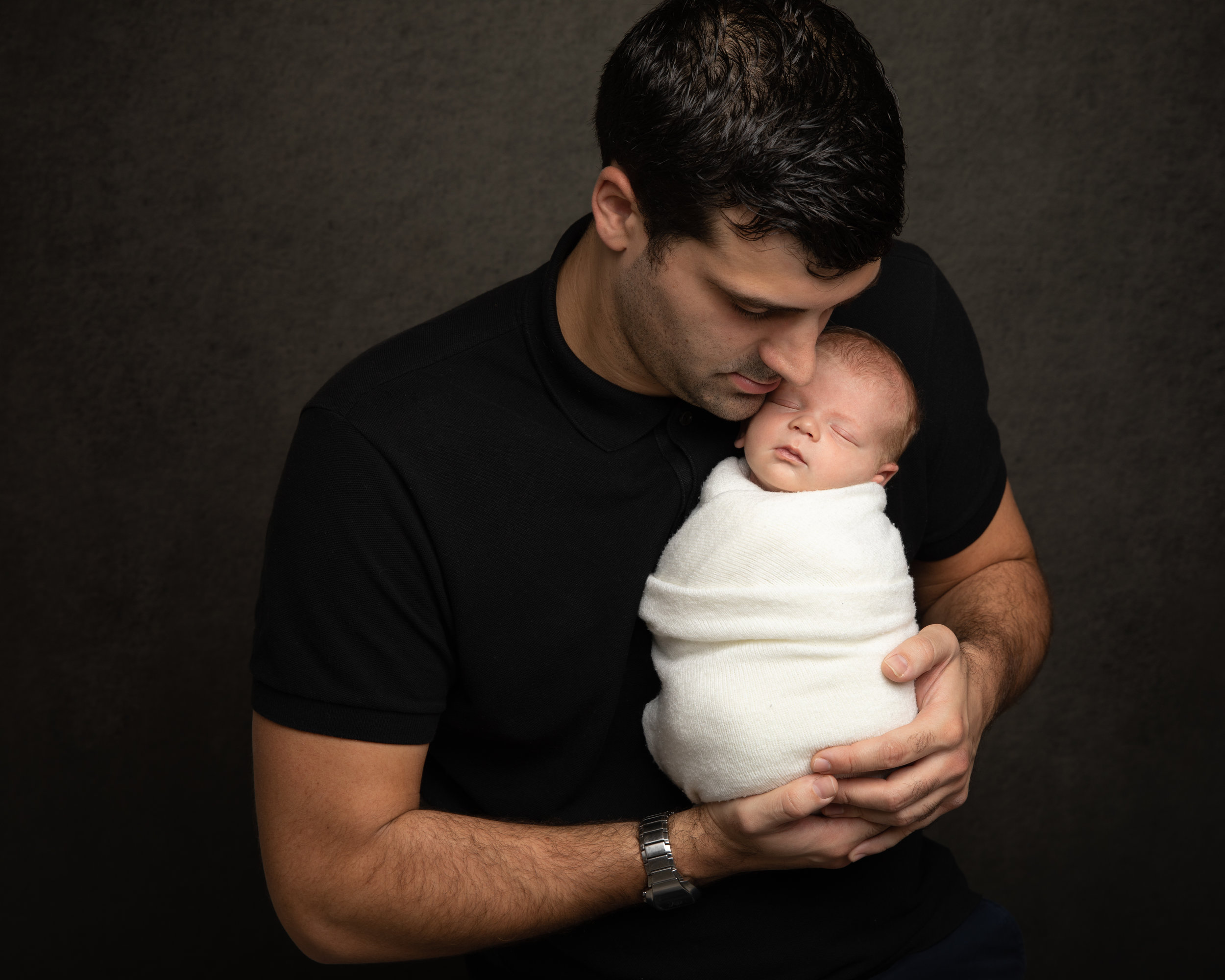 father-holding-newborn-baby-london-photographer