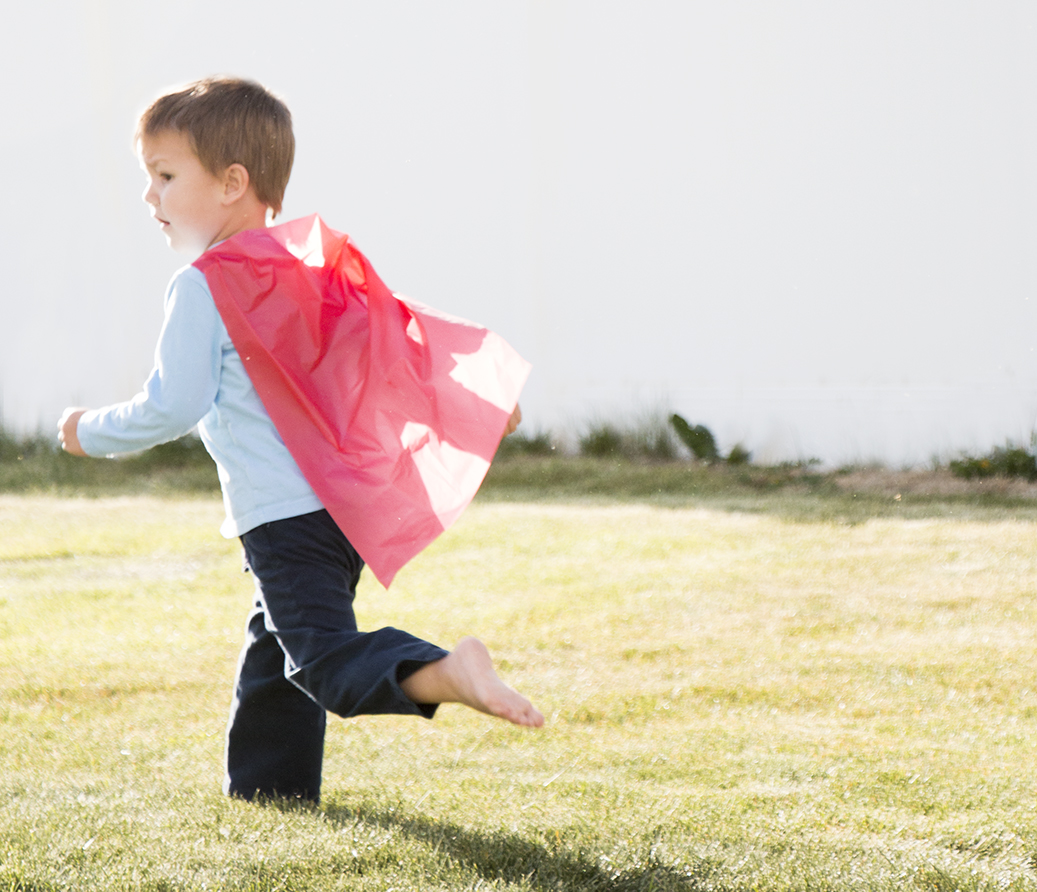 Noah, four years old, modeling a Race Bib Tape cape.