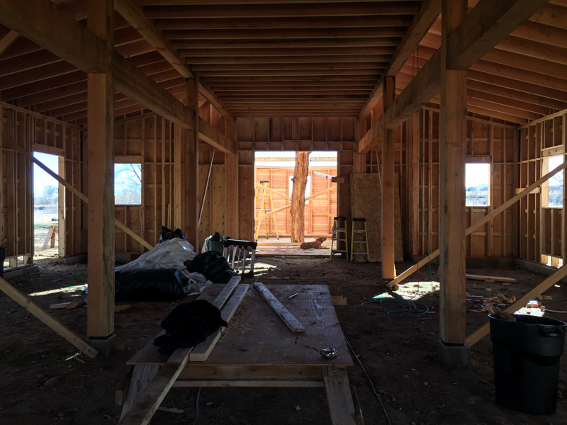 The animal stall corridor looking framing the walnut trunk and apse