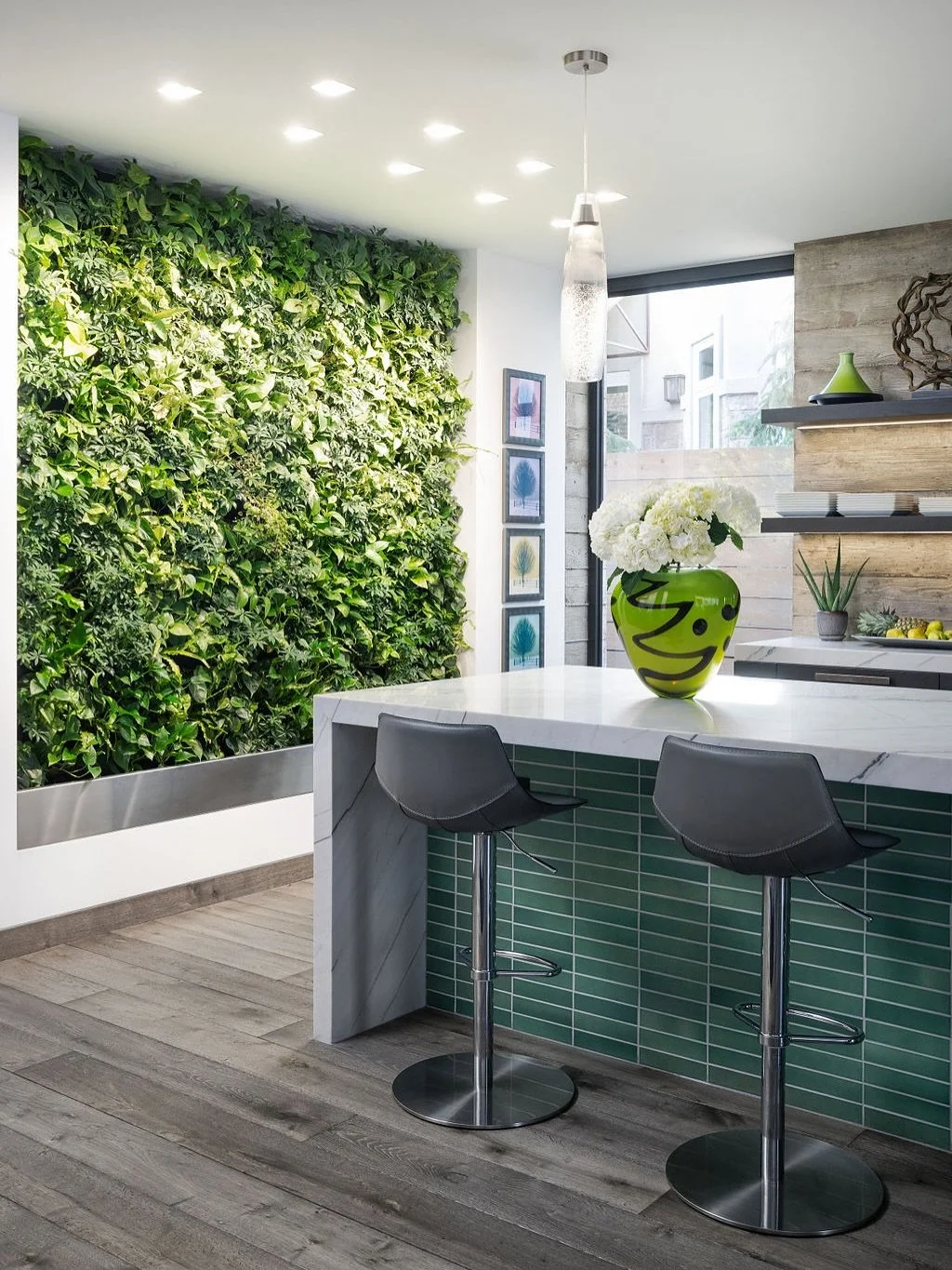 Vibrant greens give life to the raw palette of board-formed concrete and distressed oak floors at Shadow Box. Designed to support the owners colorful art collection and luscious living wall, the muted architectural palette gives deference to these to