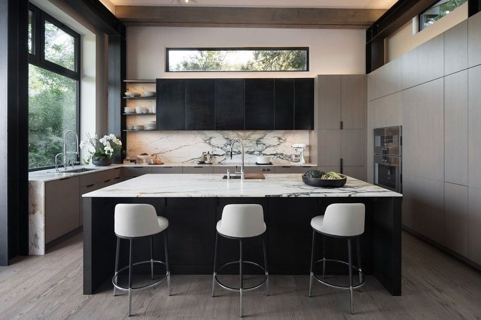 With appliances paneled in European oak, ventilation concealed behind blackened steel cabinets, and countertop storage for your morning espresso; the Rabbit Ears kitchen achieves maximal functionality with a minimalist aesthetic. 

Builder: @buildwel