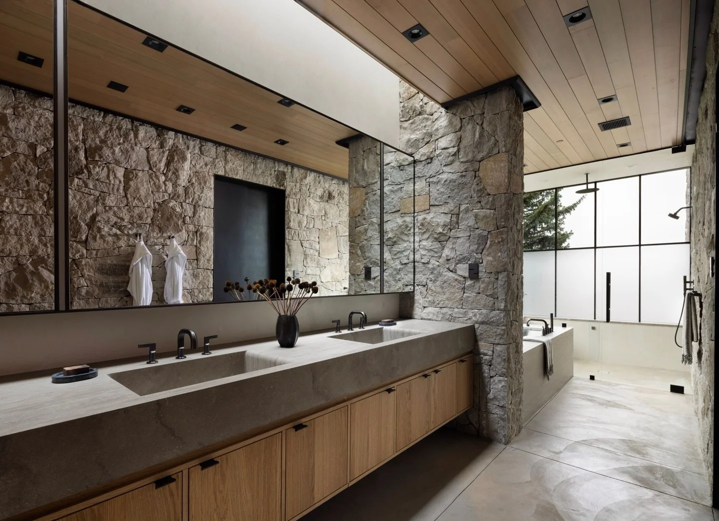 The primary bath at our Amani project was envisioned to bring solace, calming and reset to its inhabitants.
A singular slab of stone was skillfully milled into the vanity and sinks providing pure simplicity to the endpoints of the day&rsquo;s events.