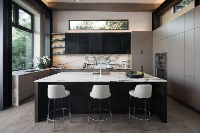 With appliances paneled in European oak, ventilation concealed behind blackened steel cabinets, and countertop storage for your morning espresso; the Rabbit Ears kitchen achieves maximal functionality with a minimalist aesthetic. 

Builder: @buildwel