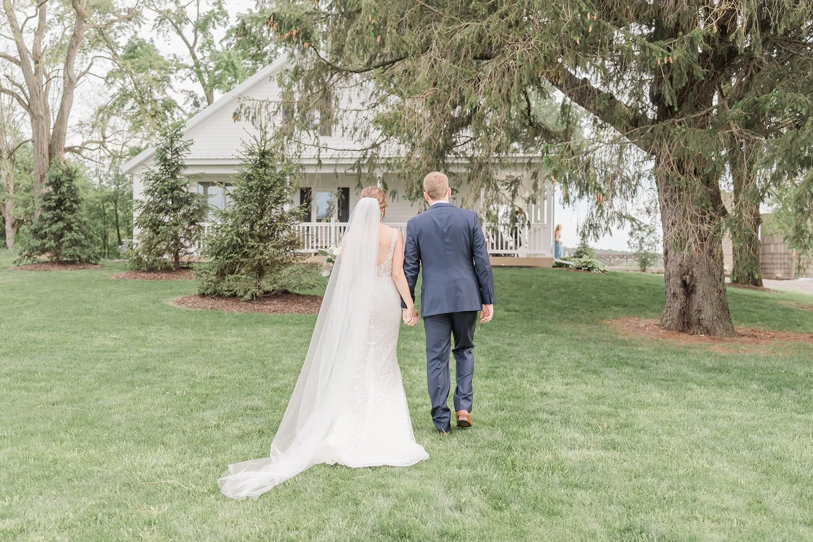 Bride and groom walking away from camera