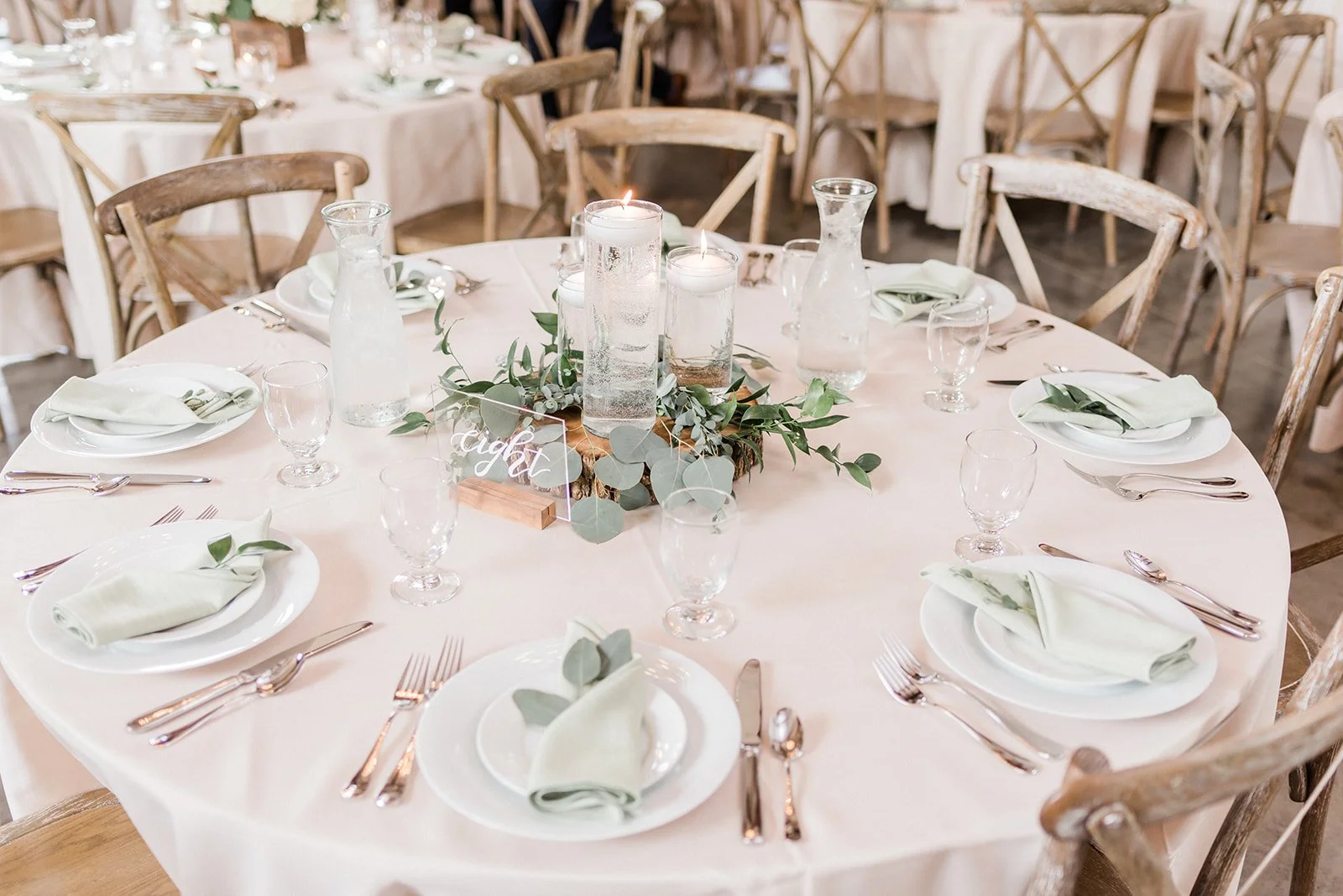Wedding table set with candles and greenery