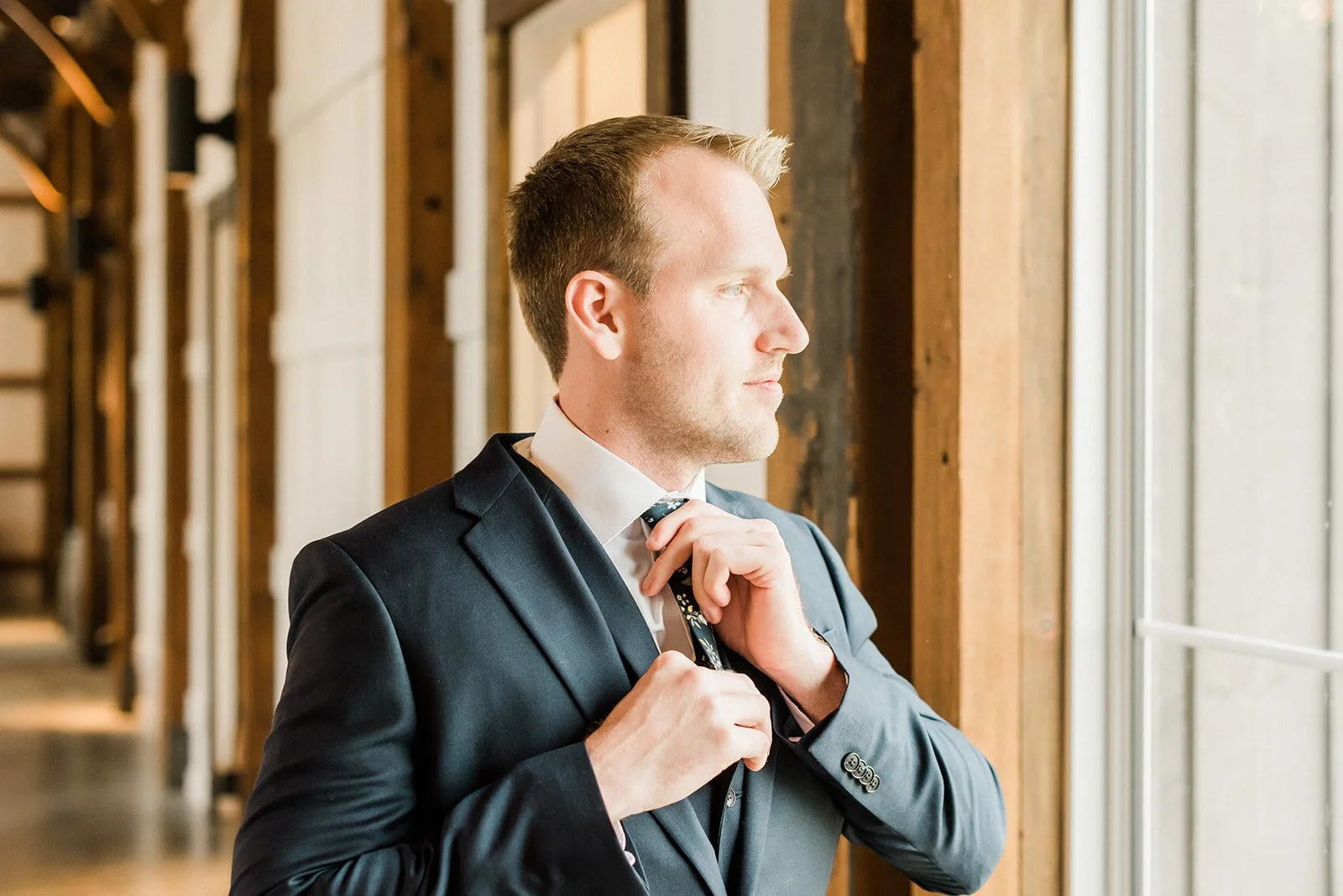 Groom fixing his tie