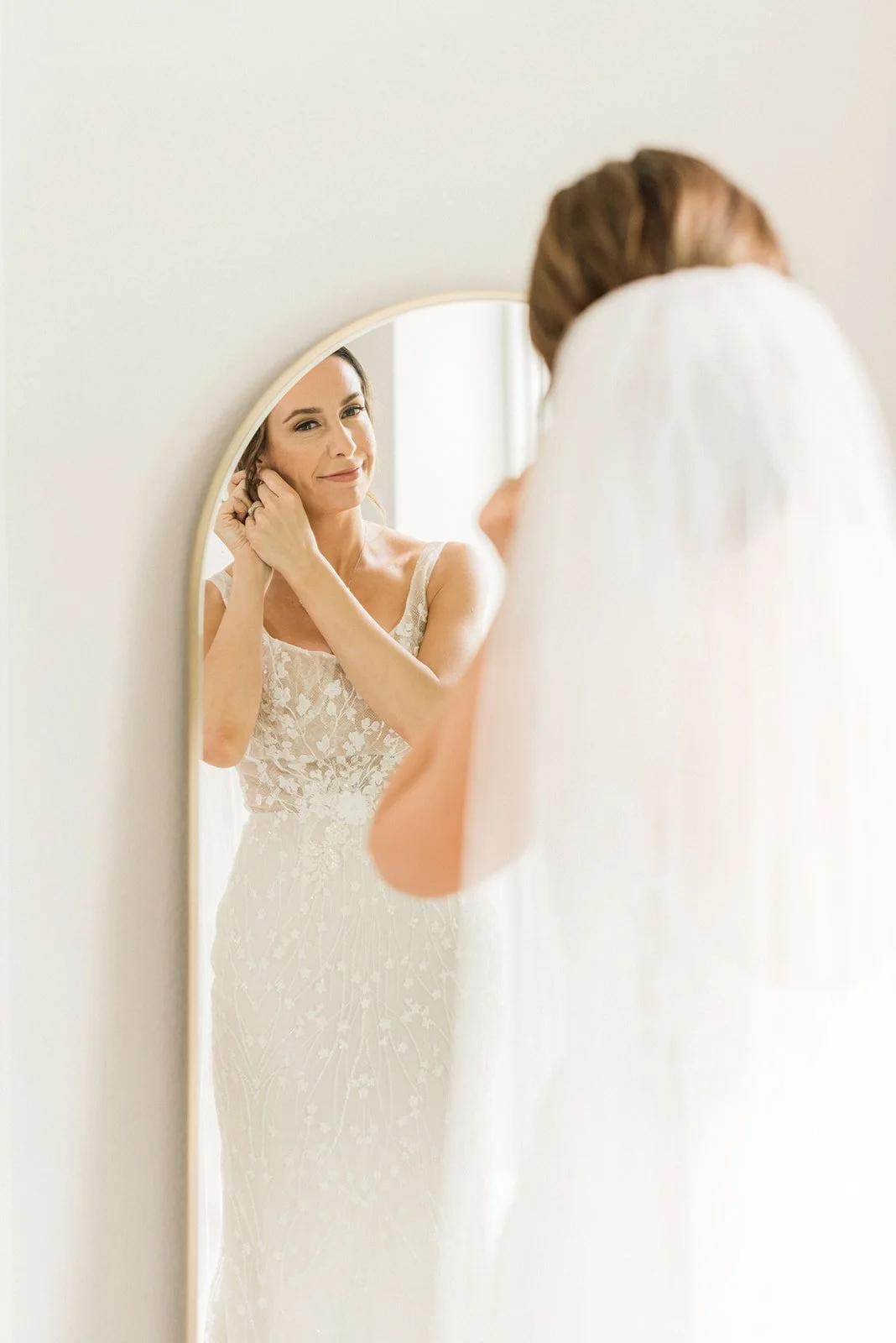Bride putting on her jewelry