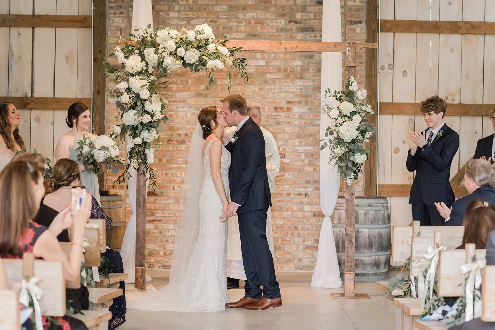 Bride and groom kiss during their ceremony