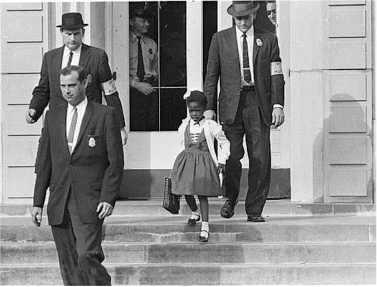 Ruby Bridges, age 6, escorted by federal marshalls