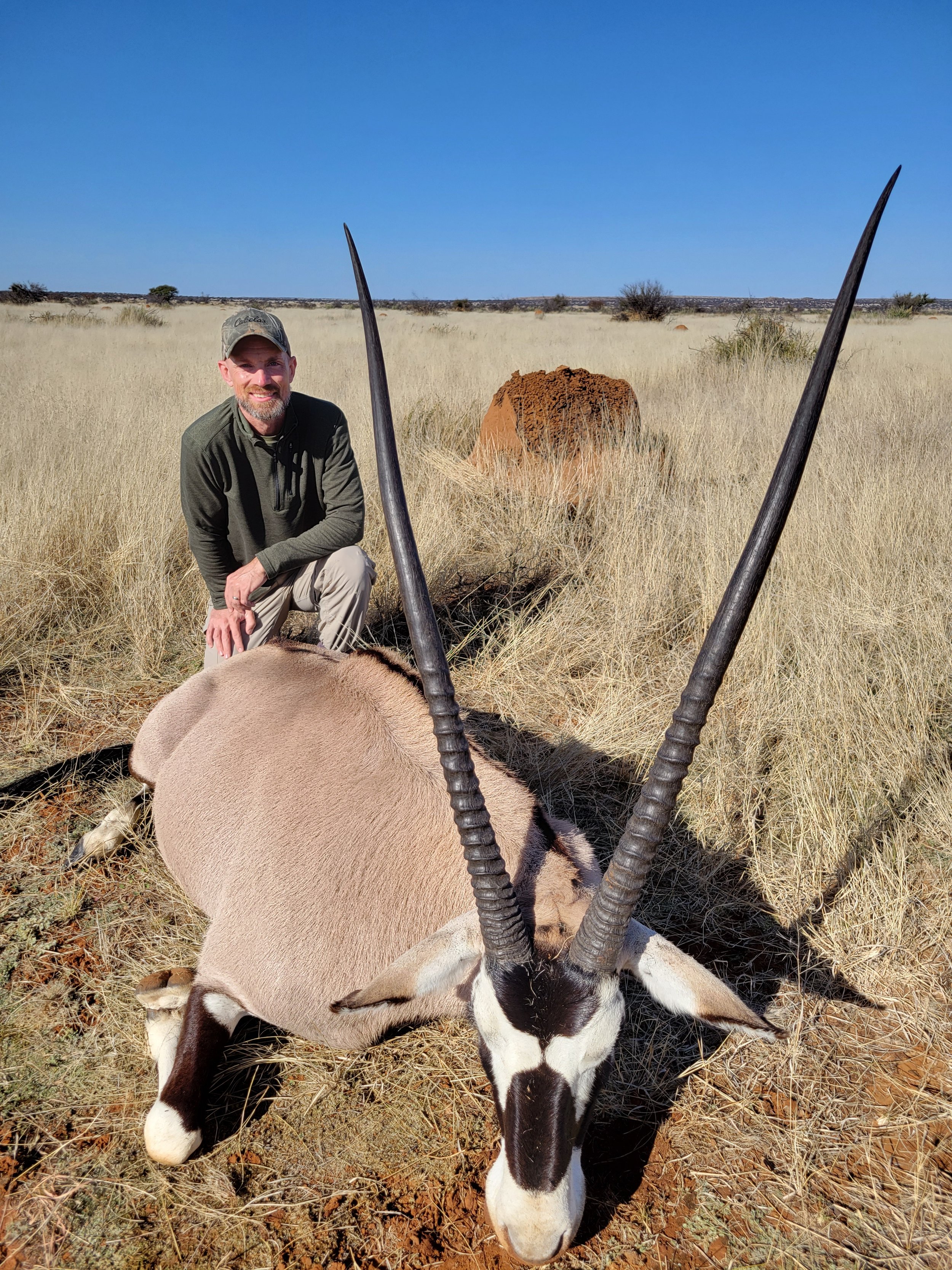 Josh with his gemsbok and ant mound in the background.jpg