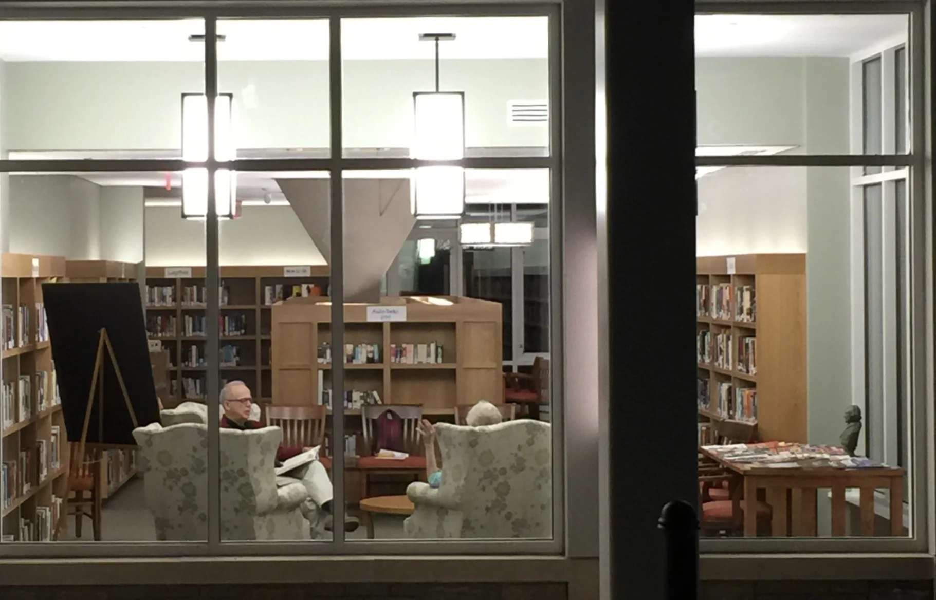 Library lit up at night, seen from outside