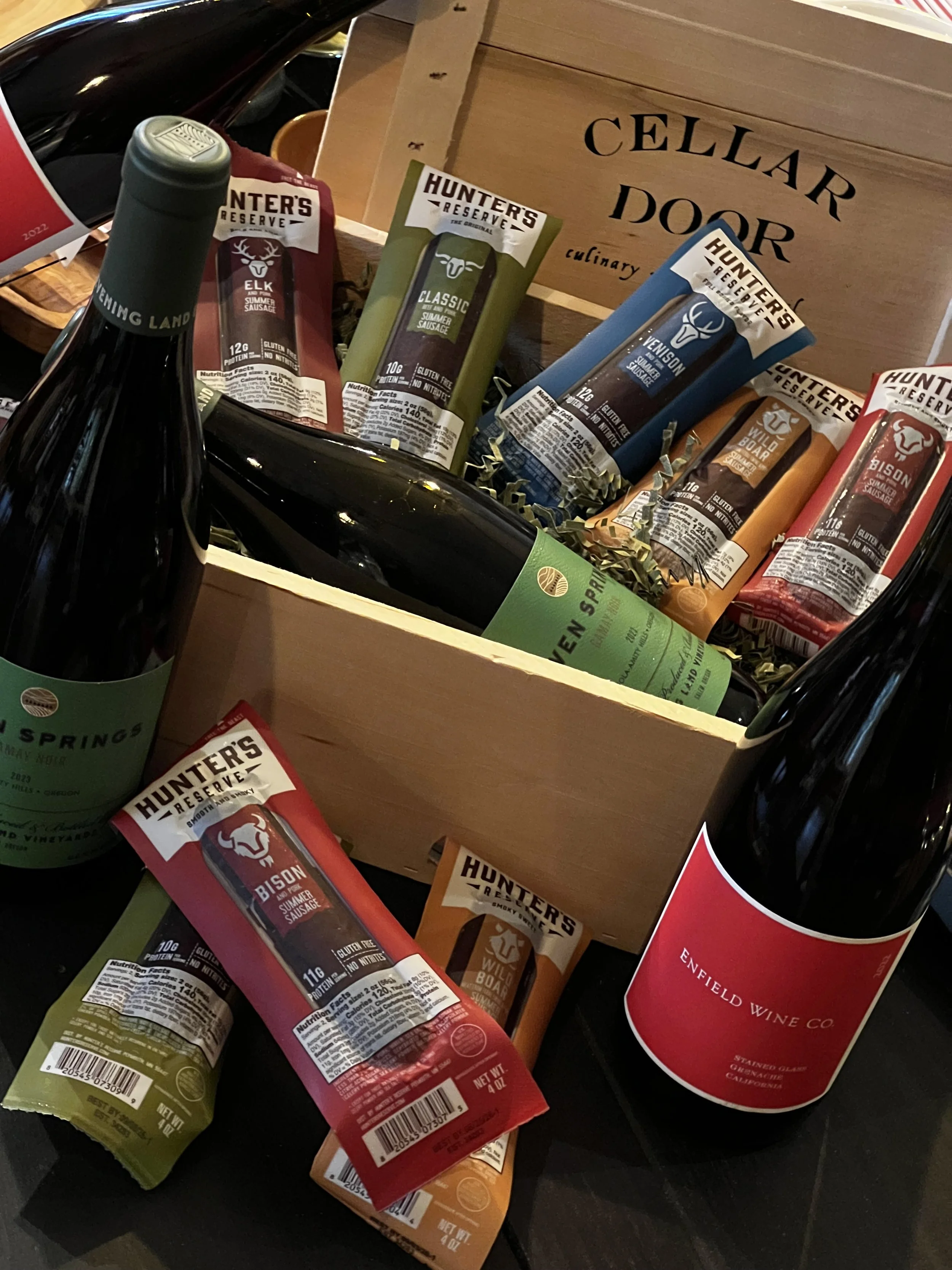Hunter's Collection Wild Sausages (Classic, Elk, Venison, Bison, Wild Boar), Evening Land 'Seven Springs' Gamay Noir from Eola-Amity Hills OR, and olivewood knife, nestled in a custom wood crate