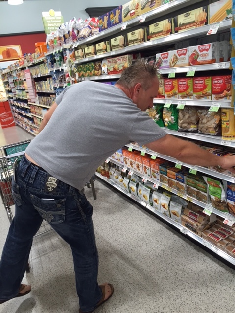 CLEANUP IN AISLE THREE  -- Men go food shopping with list in hand (and cell phone in pocket)