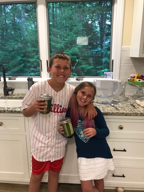 Jake and Ally Wolfson holding their home-made dill pickles!
