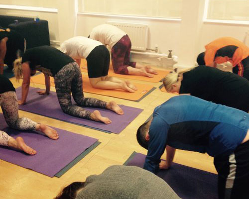 Yoga class for employees in the workplace to improve wellbeing.jpg